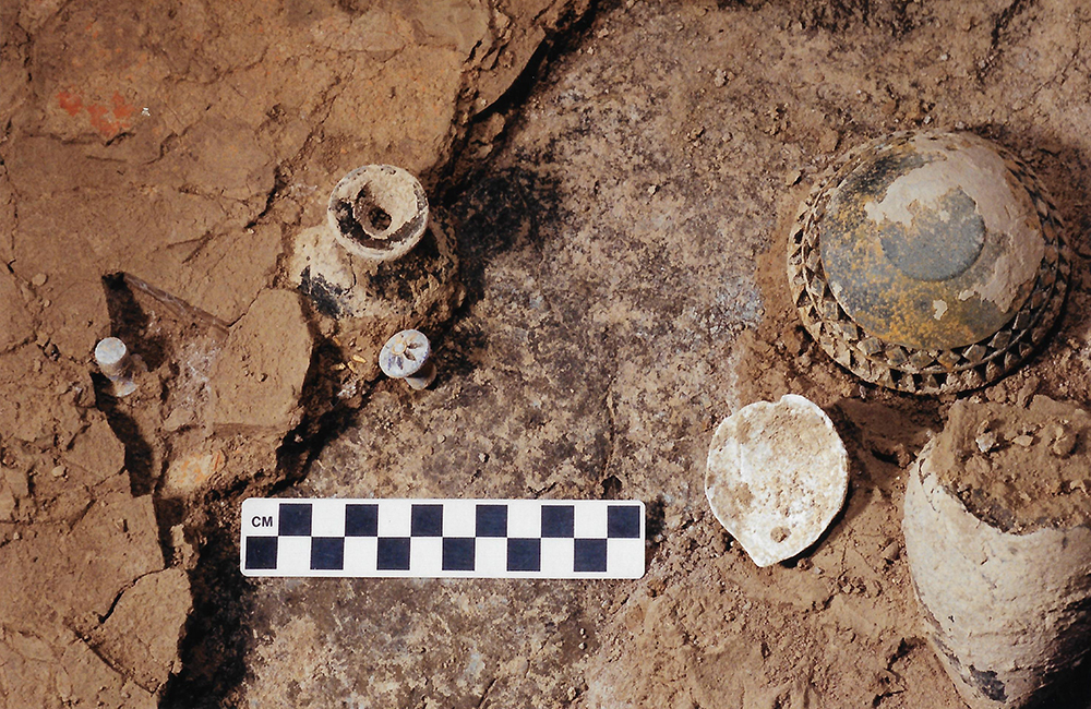 Ancient pottery in red clay earth, photographed from above