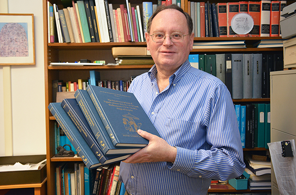 Grant Frame holds books in his office